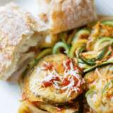 "Air fryer zucchini noodles cooked until tender and lightly crisp, served in a bowl as a low-carb pasta alternative."