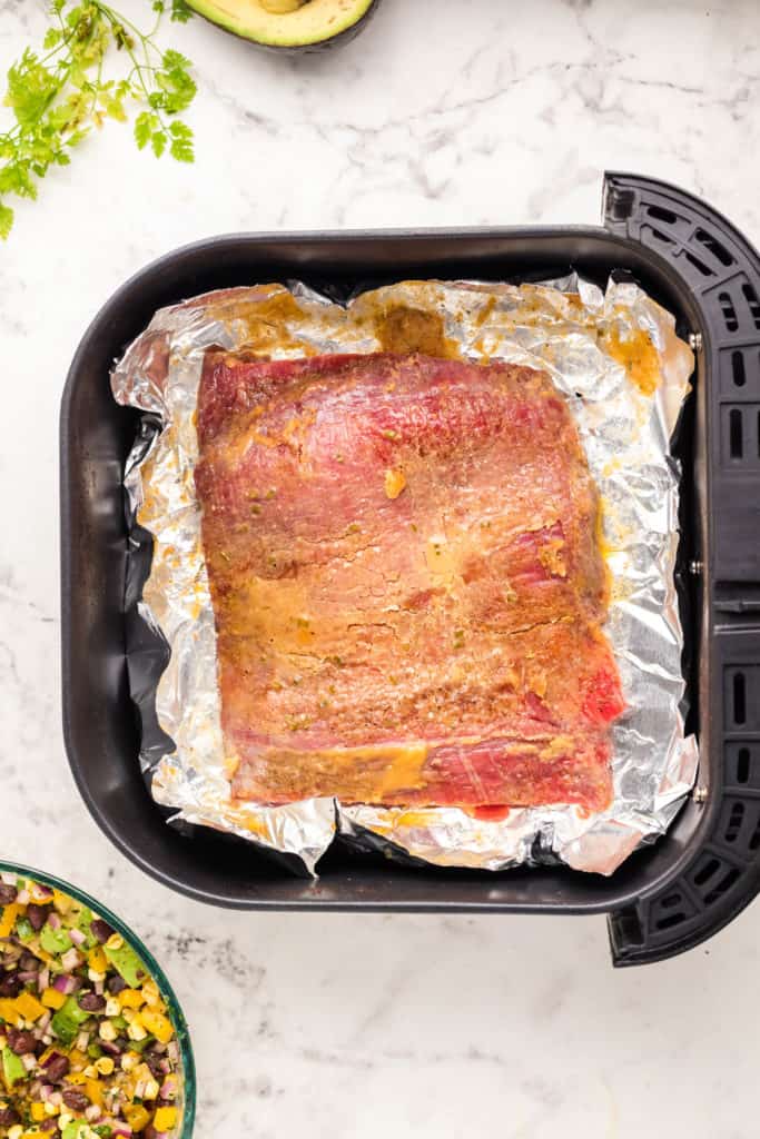 overhead: marinated flank steak in air fryer basket