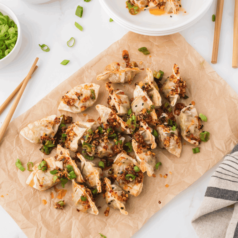 Plate of PF Chang's Pork Dumplings Recipe with sauce dripped on top of them.
