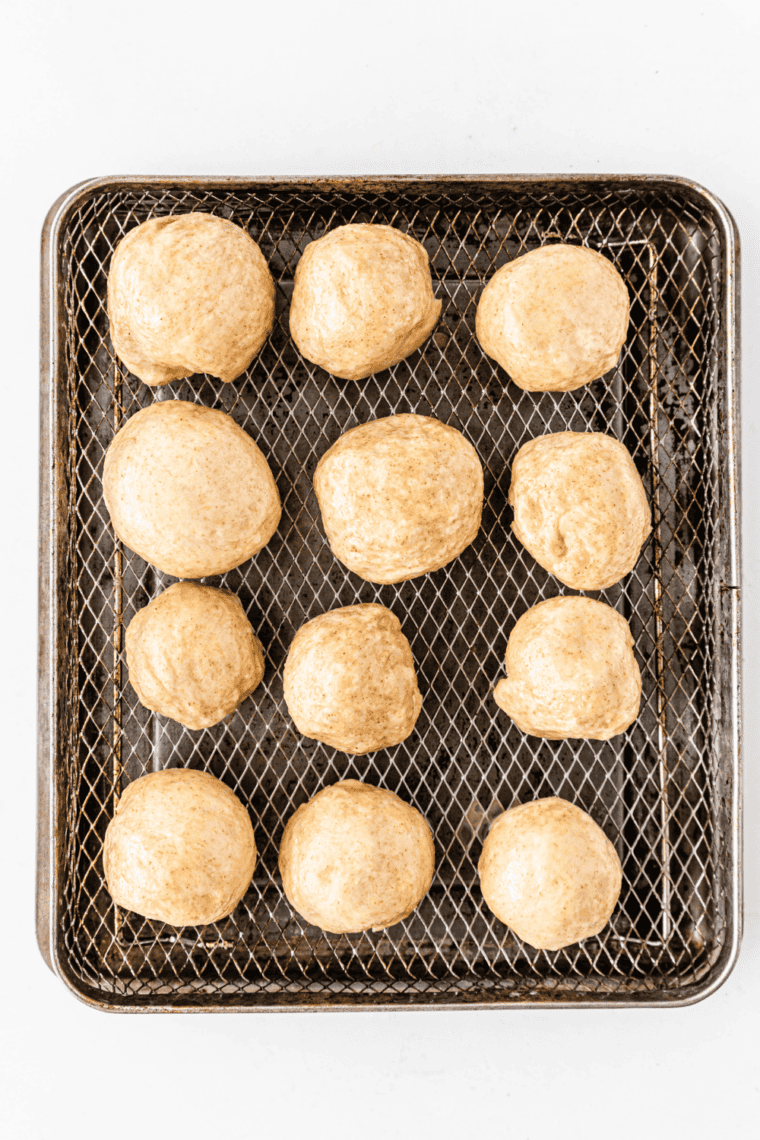 Air frying until golden brown – Pretzel bites cooking in air fryer, turning golden and puffed.