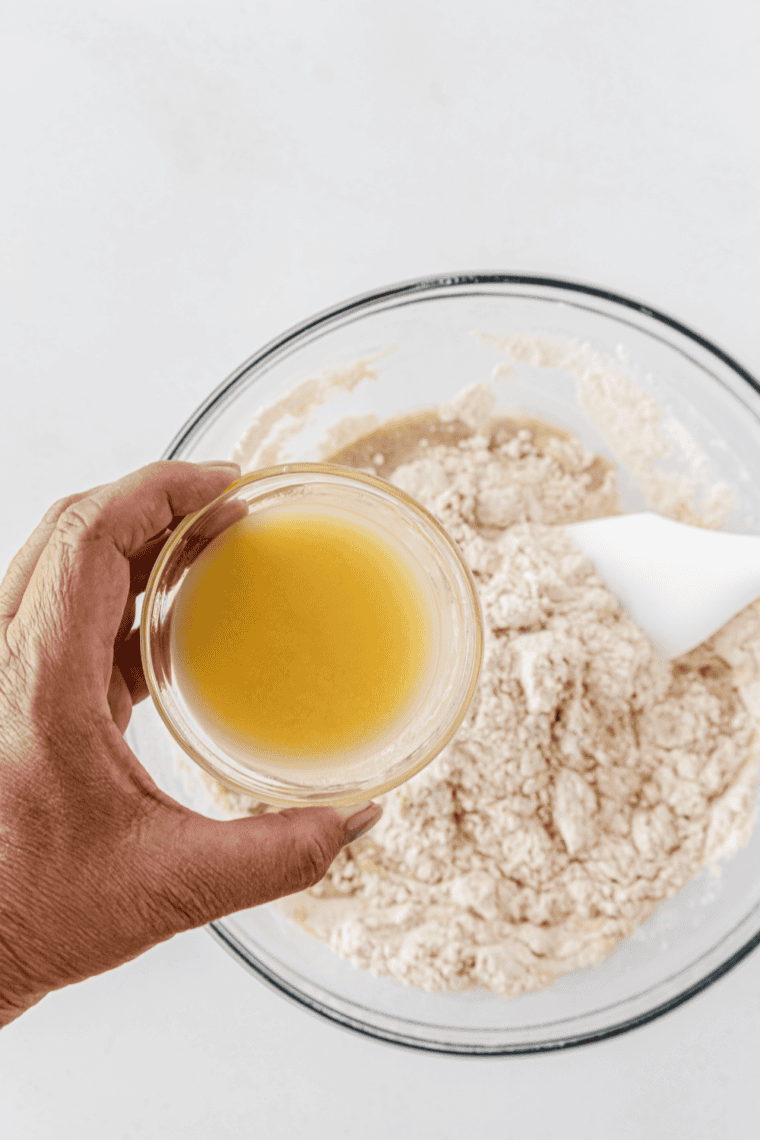 Kneading dough until smooth and elastic – Dough being kneaded on a floured surface until soft, smooth, and stretchy.