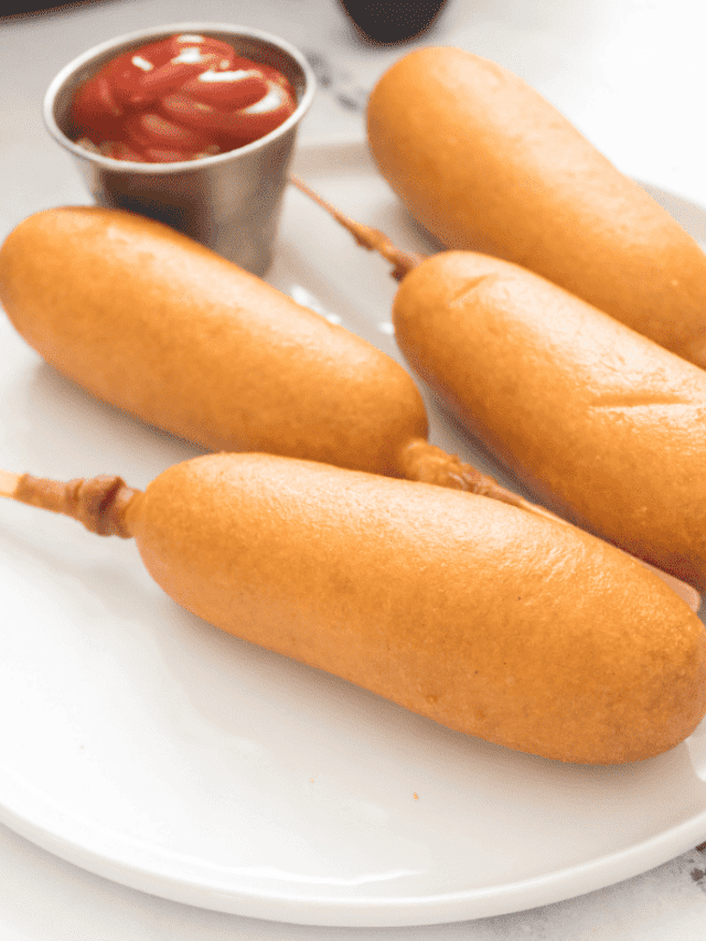 air fryer corn dogs on a plate with a side of ketchup