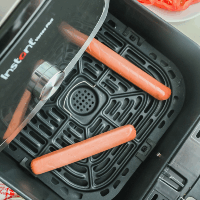 Place the hot dogs into the Air Fryer Basket.
