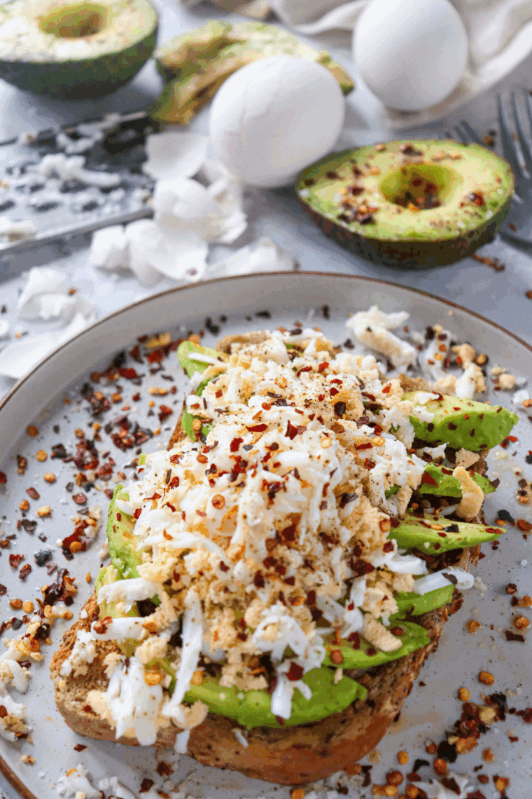 Air Fryer Avocado Toast with golden crispy bread, topped with mashed avocado and garnished with seasonings.