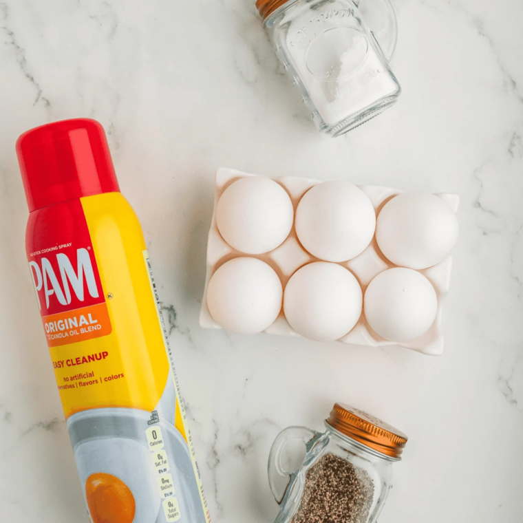 Ingredients for air fryer Canadian bacon egg cups: Canadian bacon slices, large eggs, salt, black pepper, and cooking spray