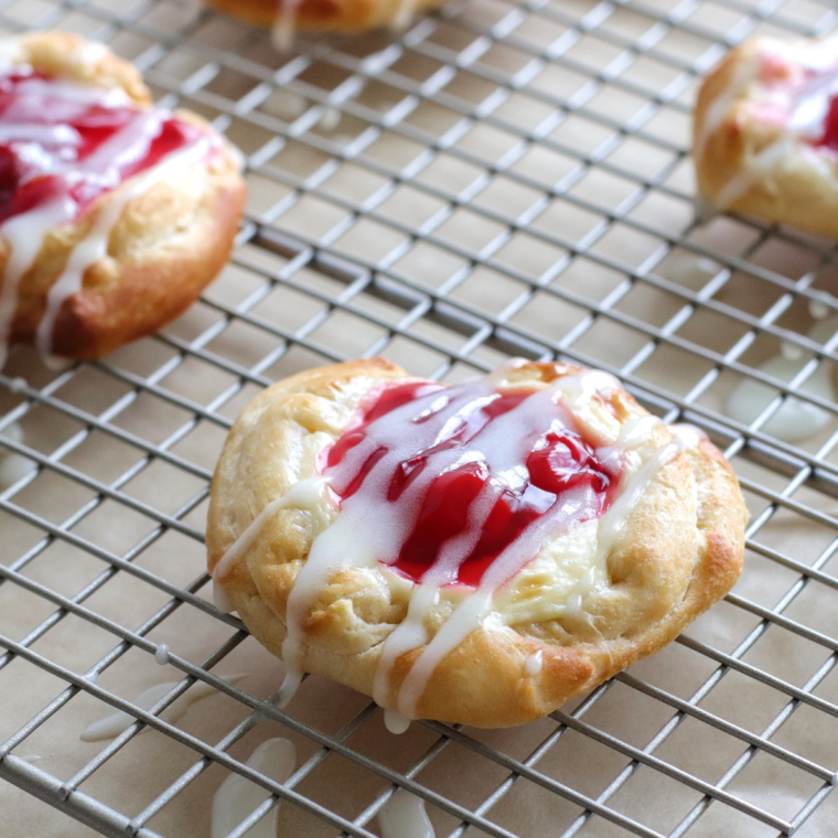 Air fryer cherry cream cheese danish with flaky pastry, cream cheese filling, and cherry topping.