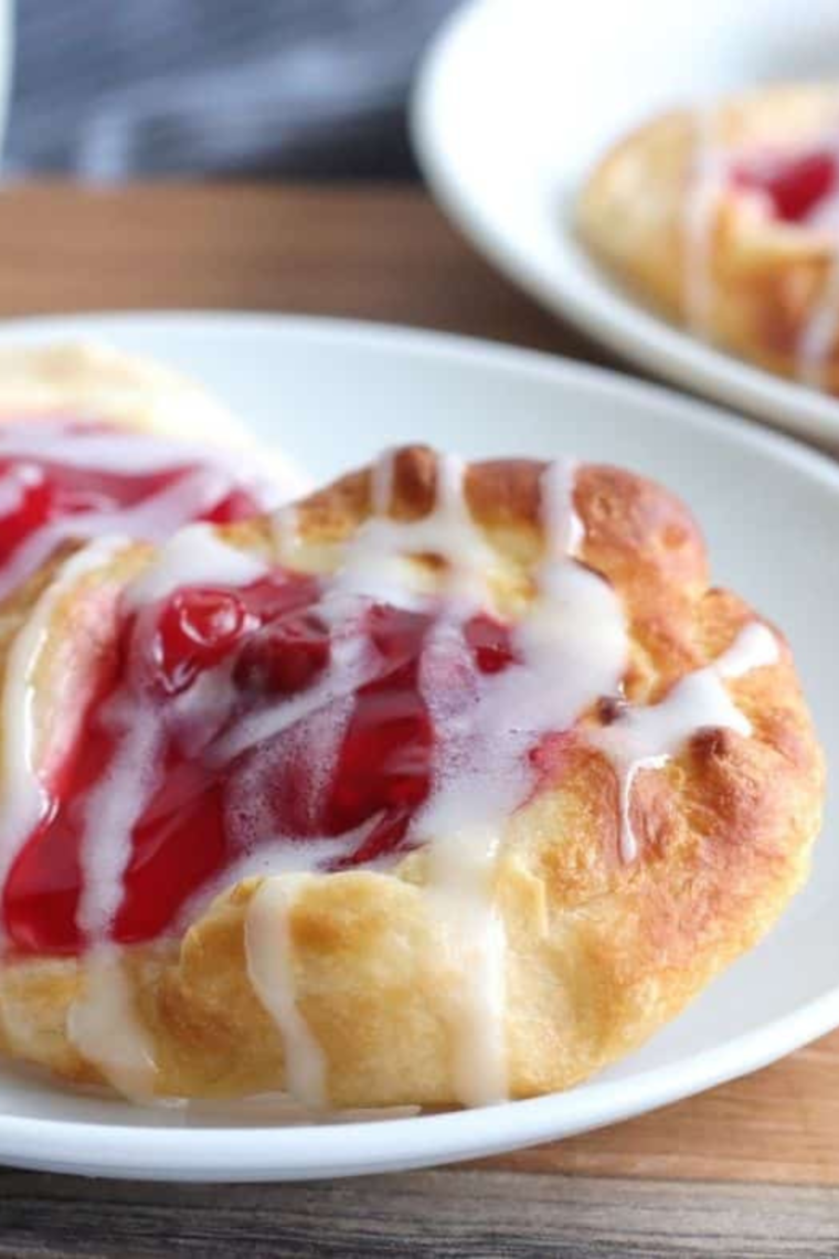 Golden brown Air Fryer Cherry Cream Cheese Danish with a flaky crust and creamy filling, topped with sweet cherry pie filling.