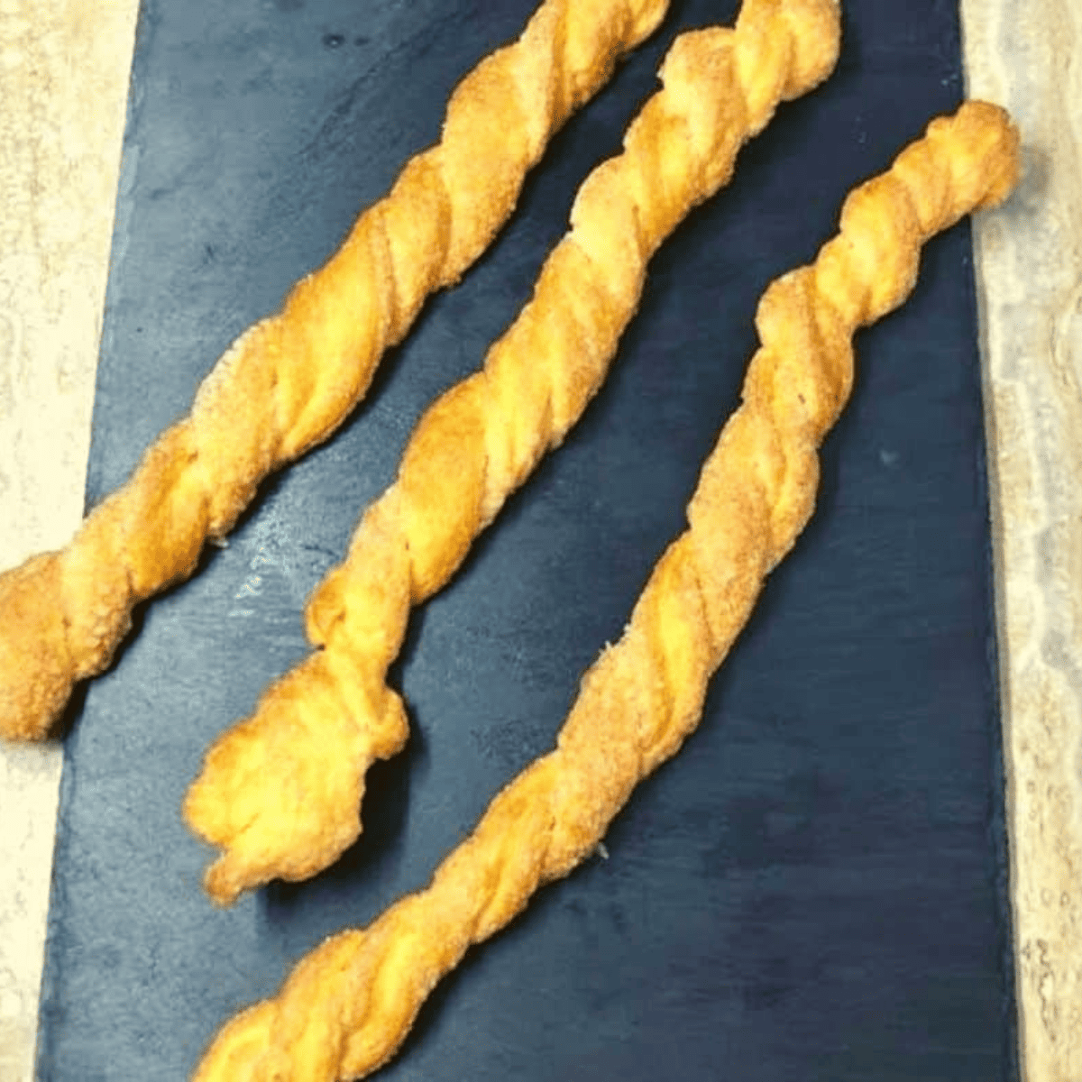 Twist the Strips: Take the long strips and twist it multiple times to create a spiral shape. Place the twisted strips on a baking sheet or plate.

Grease the Air Fryer Basket: Lightly grease the air fryer basket with cooking spray to prevent sticking.

Air Fry the Twists: Arrange the twisted pastry strips in a single layer in the air fryer basket, leaving some space between them. Depending on the size of your air fryer, you may need to cook them in batches.

Air Fry for 6-8 Minutes: Air fry the cinnamon twists at 375°F (190°C) with a cooking time of  6-8 minutes or until golden brown and crispy.

Cool and Serve: Remove the twists from the air fryer and let them cool slightly. Optionally, dust with powdered sugar for an extra touch of sweetness.

Enjoy: Serve your cinnamon roll twist while still warm and crispy. Serve with sweet cream cheese or your favorite dipping sauce.