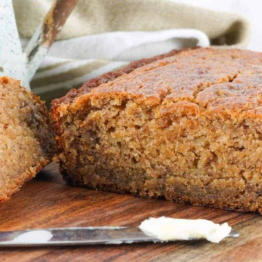 Sliced air fryer gluten-free banana bread on a wooden cutting board