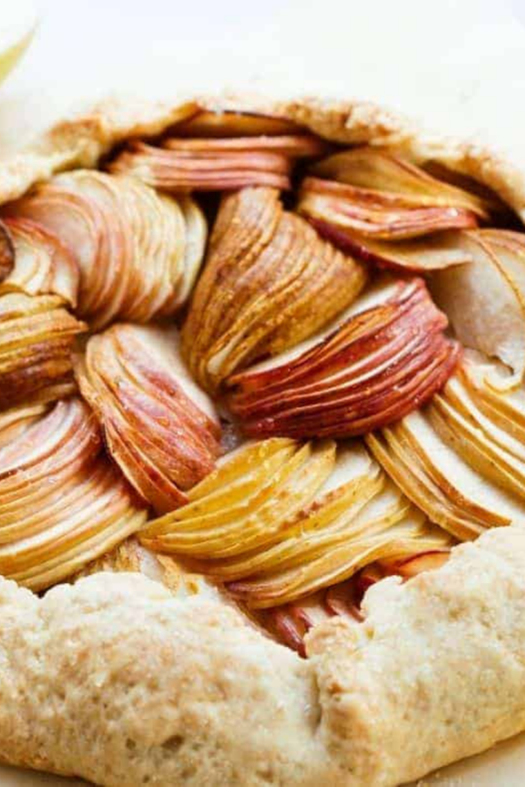 Air fryer pear galette in a tart pan with pears arranged in overlapping slices