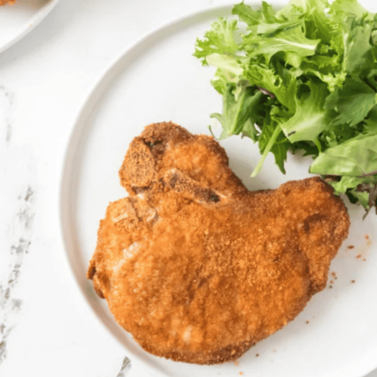  A meat thermometer checking the internal temperature of a cooked air fryer pork chop