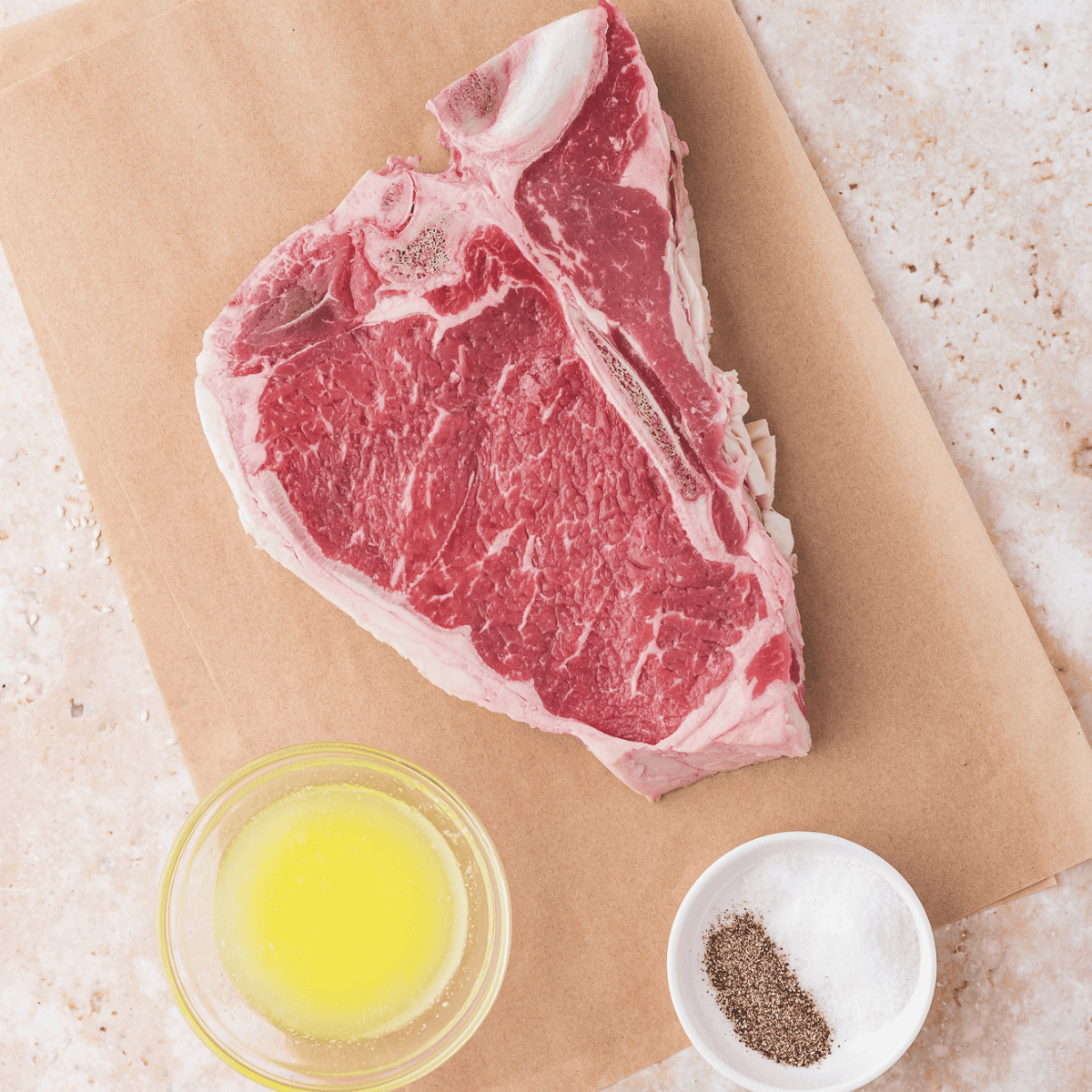 Ingredients needed for Air Fryer T Bone Steak on kitchen table.
