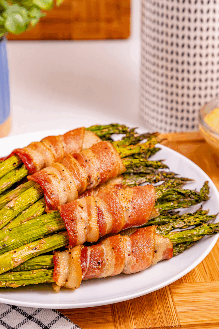 Fresh asparagus spears wrapped in bacon, cooked crispy in an air fryer.