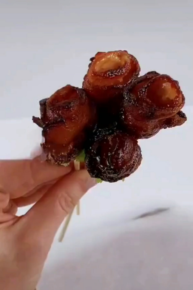 Air fryer bacon roses arranged on a plate, crispy and golden, garnished for serving