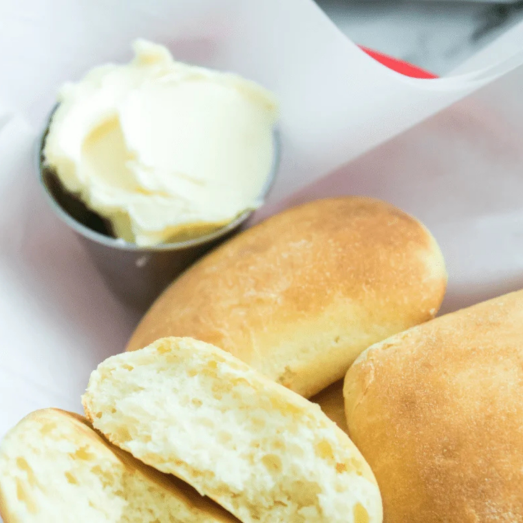 Golden brown Sister Schubert's rolls in the air fryer basket, finished and brushed with butter