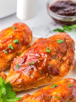 Juicy air fryer BBQ chicken breast with caramelized barbecue sauce on a white plate