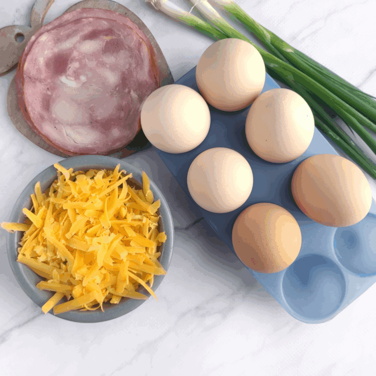 Ingredients needed for Air Fryer Breakfast Biscuits With Eggs & Bacon on kitchen table.