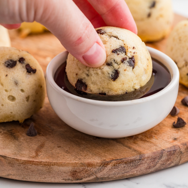 "Delicious golden-brown Air Fryer Chocolate Chip Pancake Bites topped with melted chocolate chips."