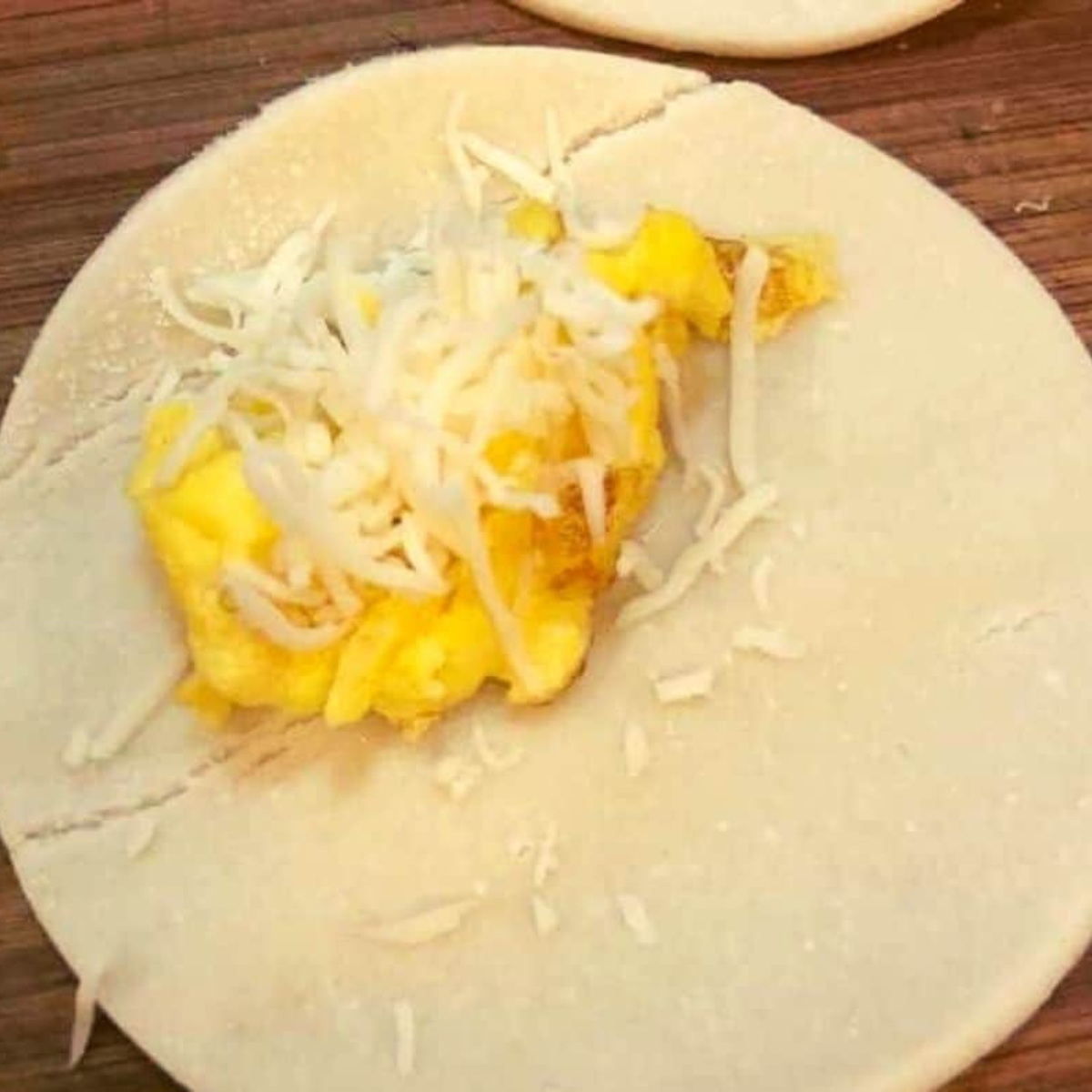  Filling the bagel pockets with scrambled eggs and cheese.