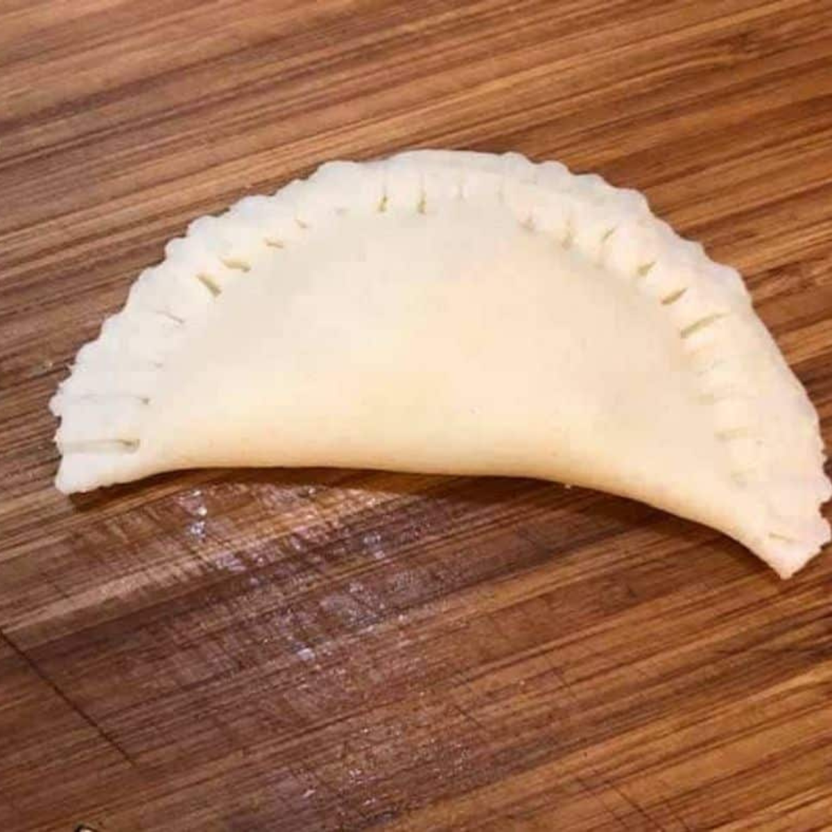 Sealing the edges of the breakfast pockets before air frying.