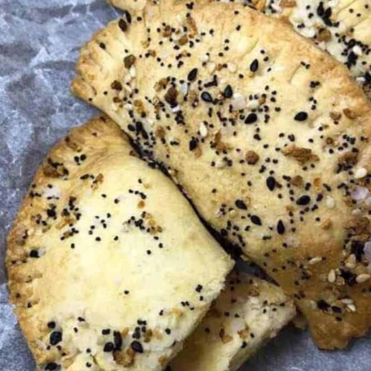 Air Fryer Everything Bagel Breakfast Pockets filled with eggs, cheese, and vegetables, served on a plate.