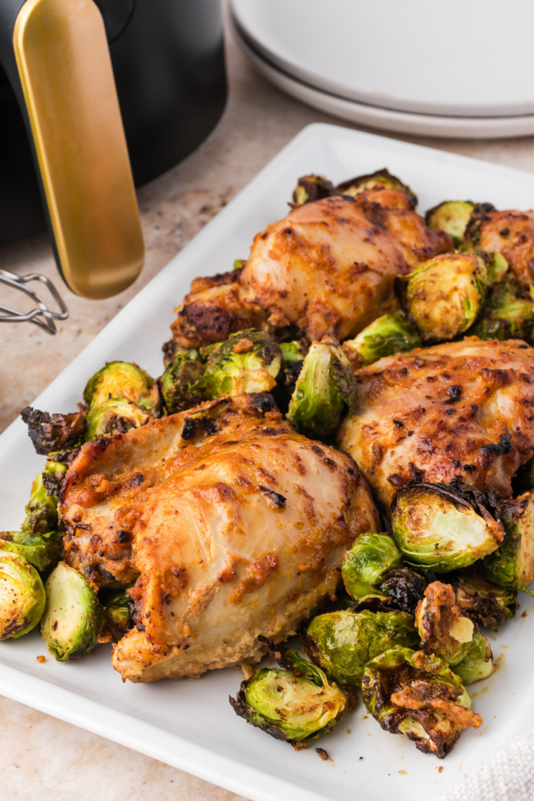 Dinner plate of caramelized honey balsamic Brussels sprouts and roasted chicken thighs with crispy skin