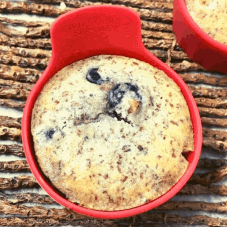 Golden, fluffy keto blueberry muffins baked in the air fryer with fresh blueberries