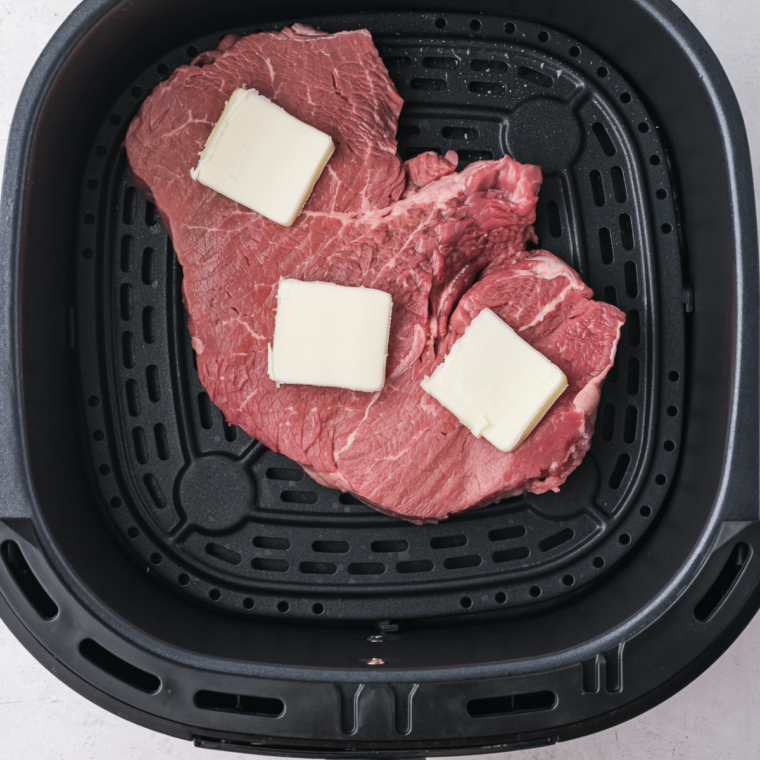 Raw steaks patted dry and seasoned with salt, pepper, and olive oil for a flavorful crust