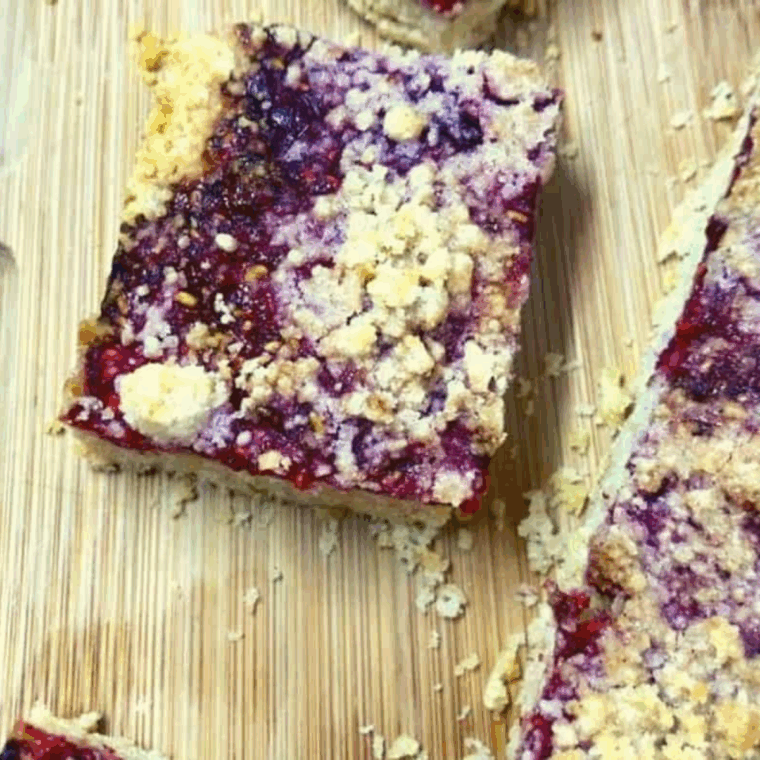 Golden Air Fryer Raspberry Pie Bars with crumbly topping and sweet raspberry filling, served on a plate.