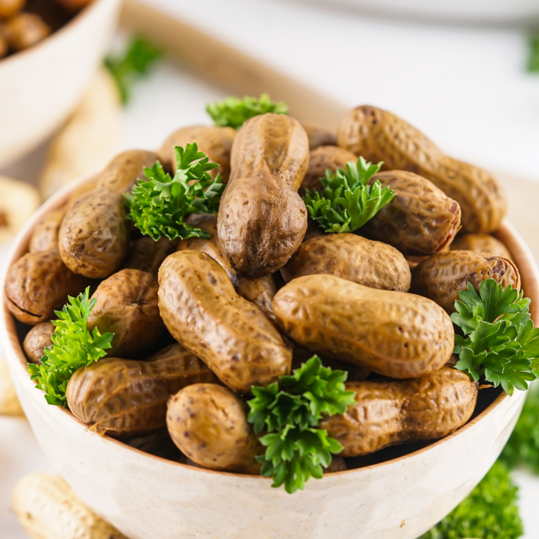 Golden roasted peanuts in the shell fresh from the air fryer, served in a bowl.