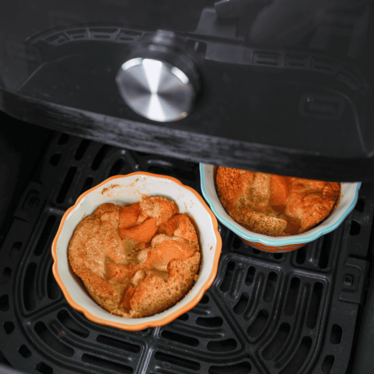 Peach cobbler cooking in air fryer until golden