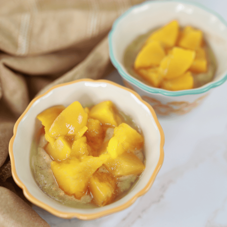Peach filling topped with batter in baking dish.