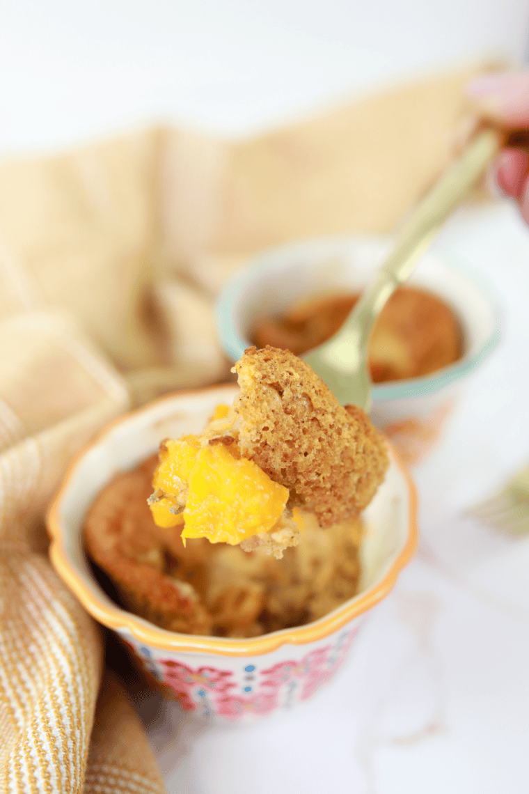 Golden gluten-free peach cobbler bubbling in an air fryer-safe dish