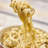 Bowl of Instant Pot Parmesan Pasta Roni Copycat with creamy cheese sauce and grated Parmesan on top