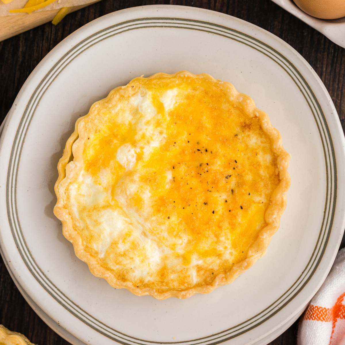 "Close-up of La Madeleine Quiche Lorraine slice with creamy egg filling"