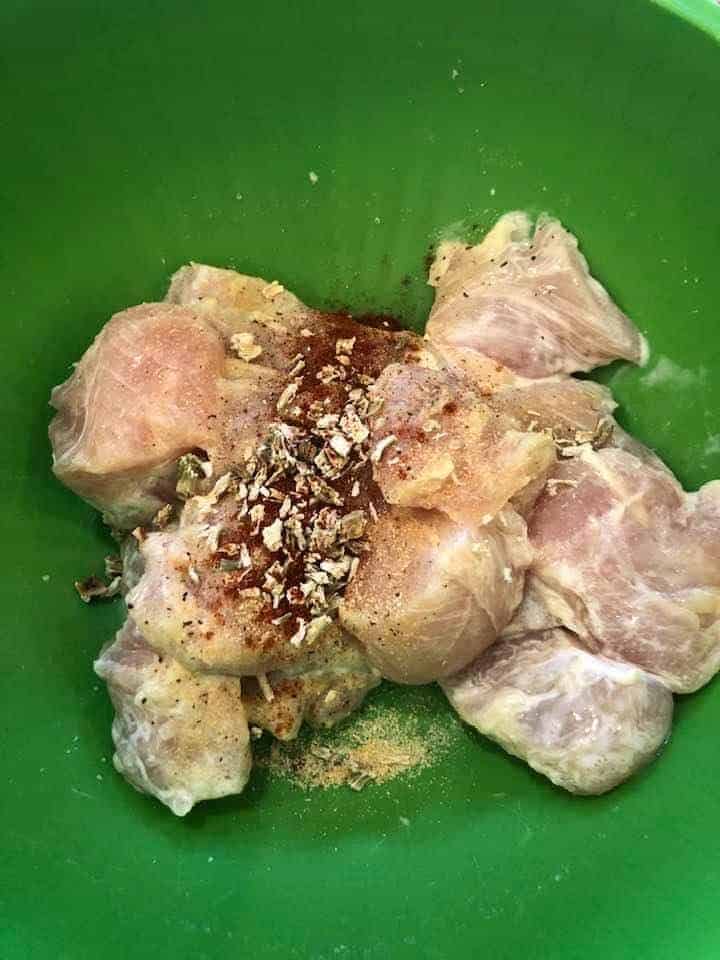 seasonings and chicken in a bowl