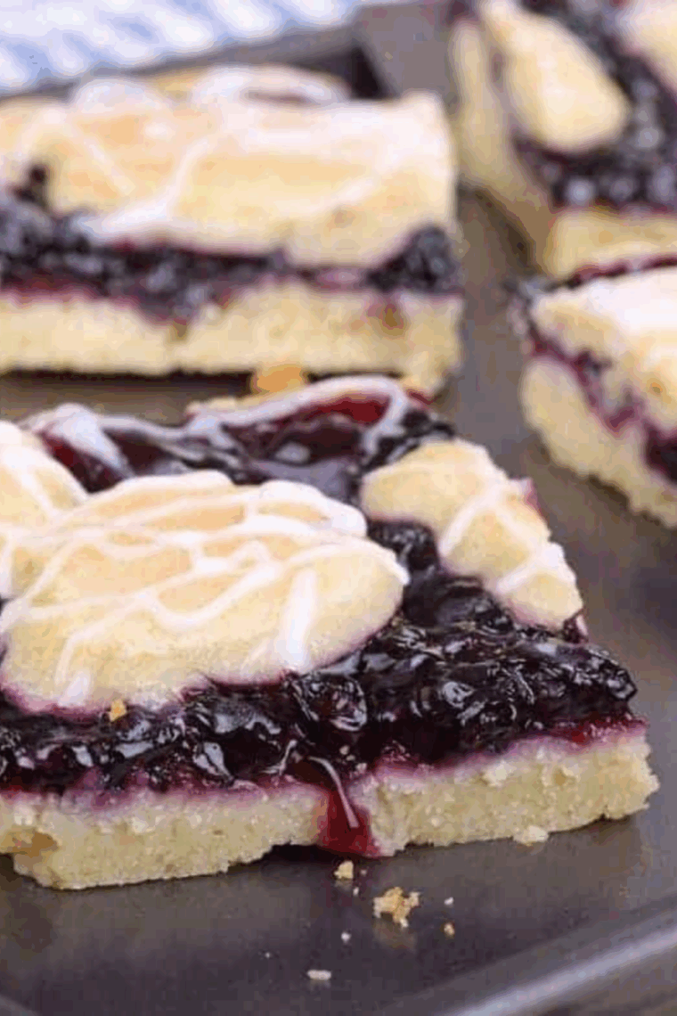 Golden-brown blueberry pie bars made in the air fryer, sliced into squares with thick blueberry filling.
