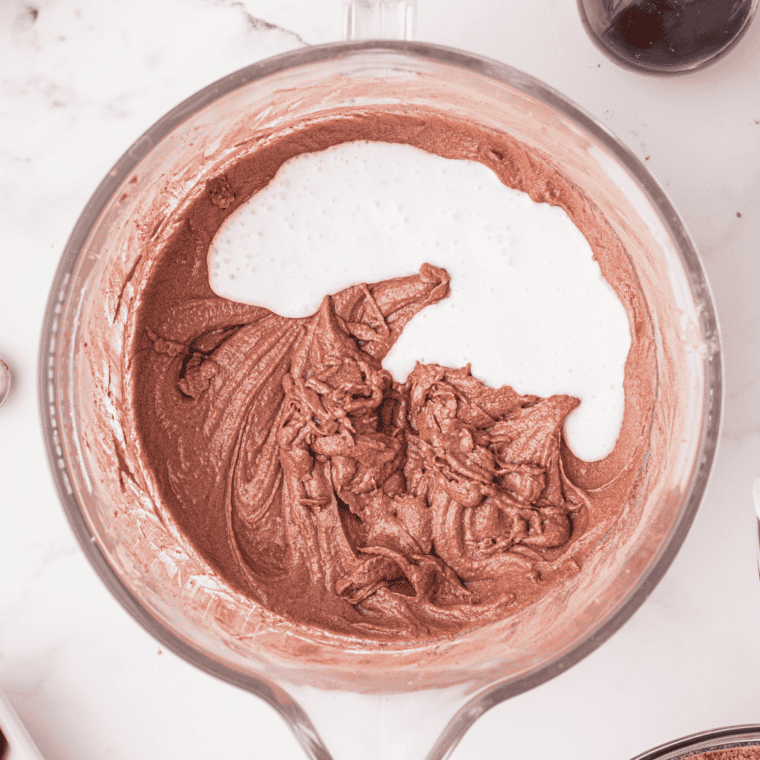 Mixing dough until it forms and spraying mold with cooking spray.