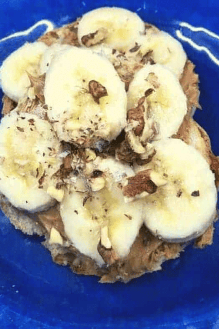 Toasted English muffins topped with peanut butter, banana slices, and crushed nuts, fresh from the air fryer.