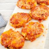 Air fryer biscuit pizza with golden crisp crusts and melted mozzarella served on a white plate