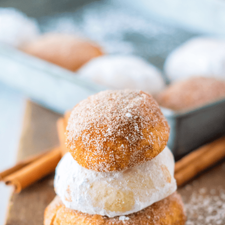 Air fryer churro donut holes coated in cinnamon sugar on serving plate