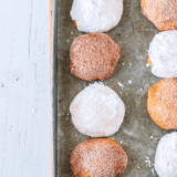Air fryer churro donut holes coated in cinnamon sugar on serving plate