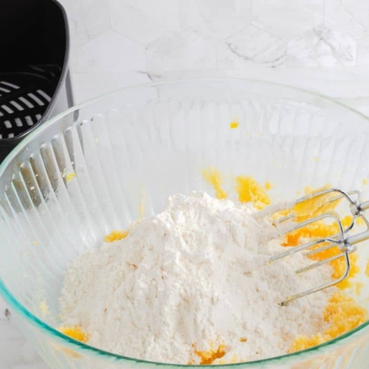 Mixing butter and sugars in a bowl for cookie dough"