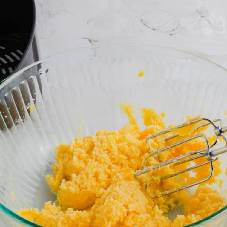 Mixing butter and sugars in a bowl for cookie dough