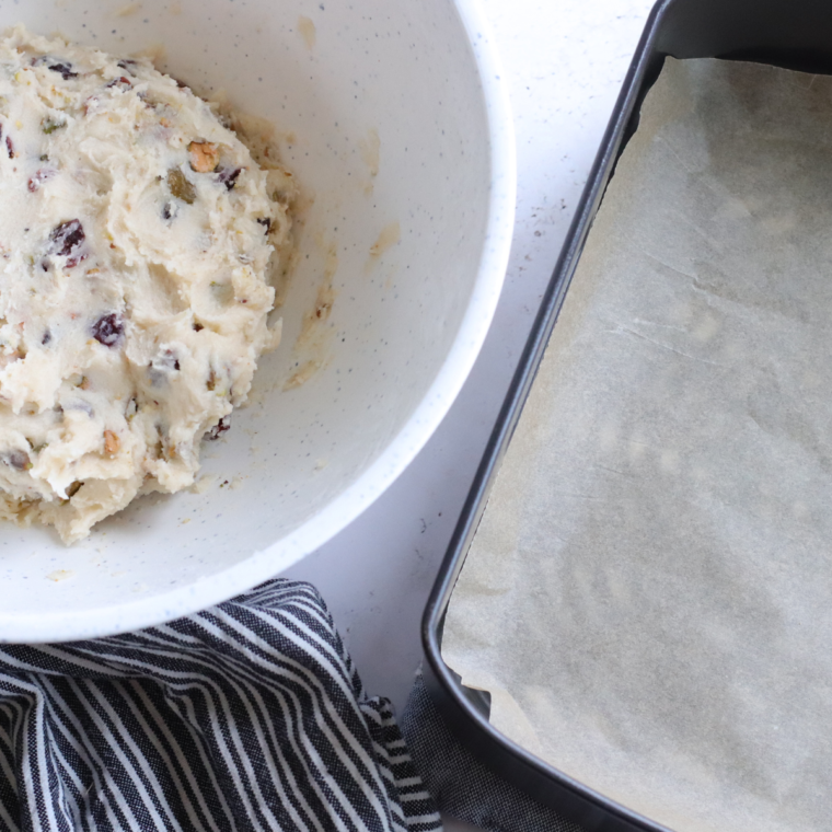 "Adding flour, cranberries, and white chocolate chips to the cookie dough"