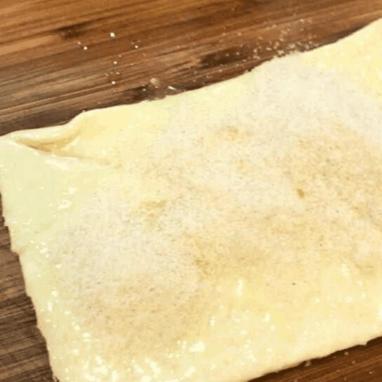 Laying out the crescent dough onto the cutting board.