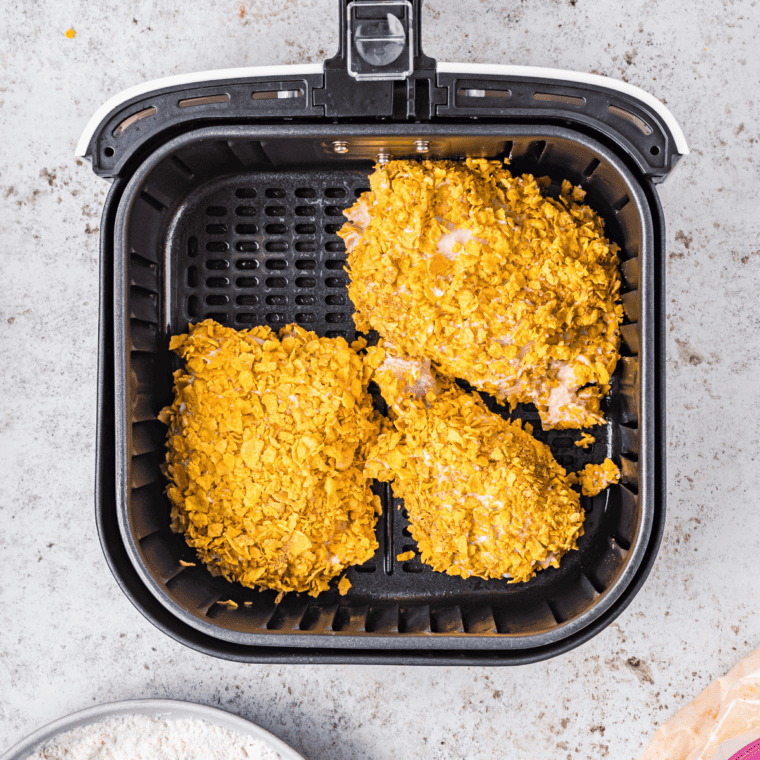 Chicken pressed into crushed French's onions for an even crunchy coating