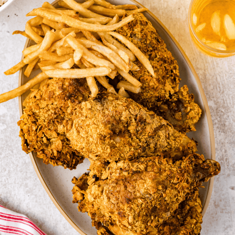 Onion-crusted chicken halfway through air frying, coating turning golden brown