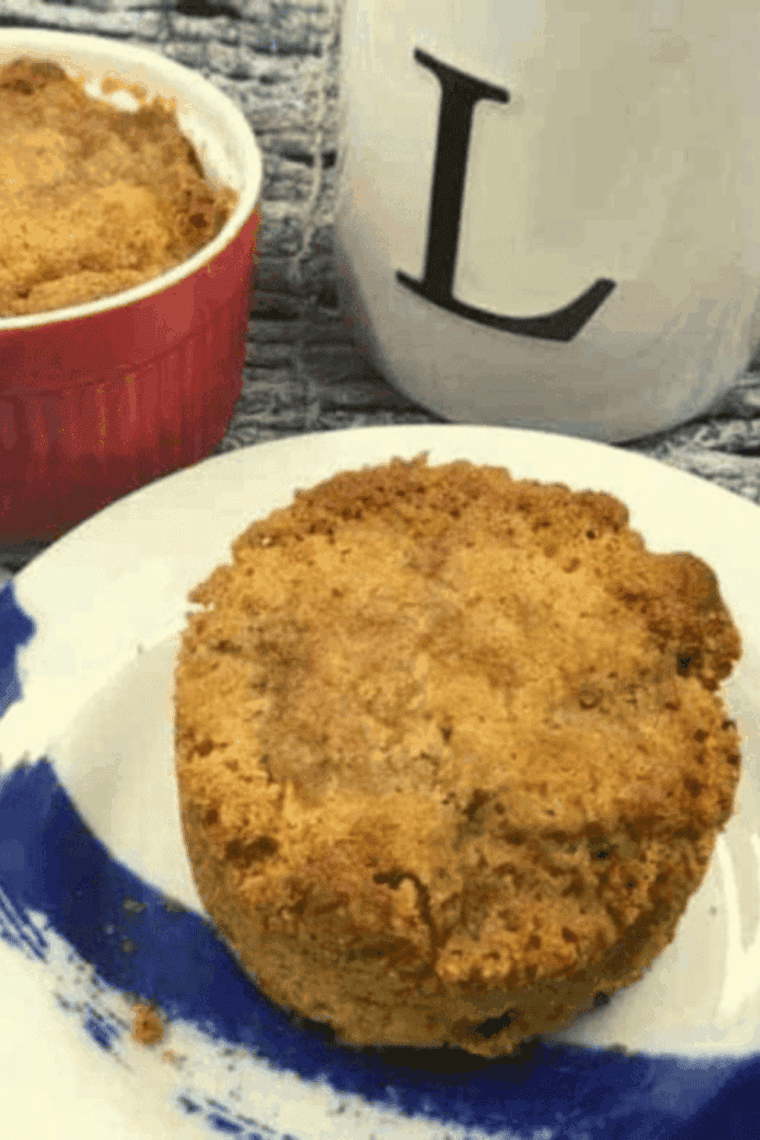 Two golden-brown air fryer apple muffins with diced apples and cinnamon, served fresh.
