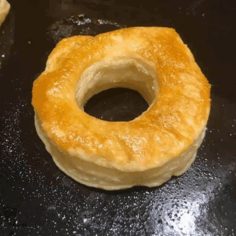 Air frying puff pastry donuts in a single layer until golden and puffed.